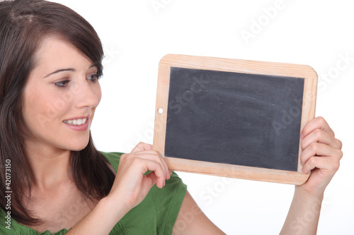 Photo: pretty woman showing a plate pretty woman showing a plate