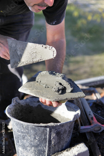 Photo: Man with cement and trowel Man with cement and trowel