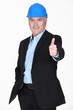 Middle-aged architect giving thumbs-up