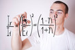 student writing mathematical exercise in the foreground