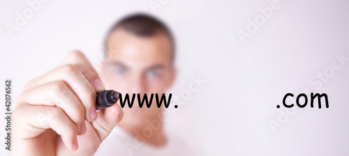 Photo: man writing the name of the site man writing the name of the site