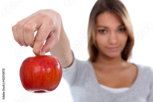 Photo: Brunette holding red apple Brunette holding red apple