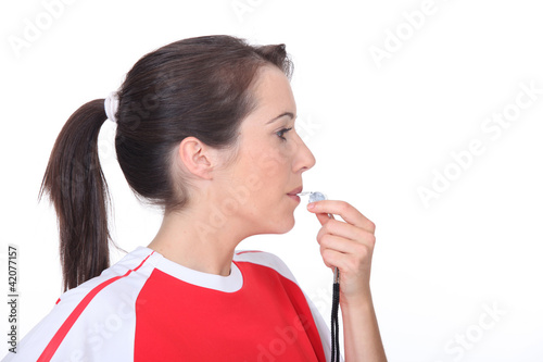 Photo: Woman blowing a whistle Woman blowing a whistle