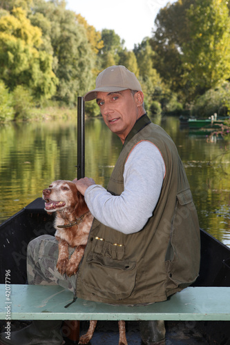 Photo: Hunter on a boat with his dog Hunter on a boat with his dog