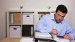 Video: Manager working at his desk with calculator and smiling in the c Manager working at his desk with calculator and smiling in the c