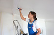 Woman painting a ceiling