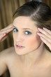 naked woman touching her temples