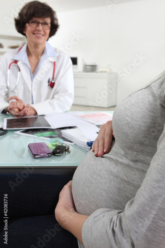Photo: pregnant woman with female obstetrician pregnant woman with female obstetrician
