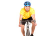 A smiling bicyclist with yellow shirt posing on a bicycle