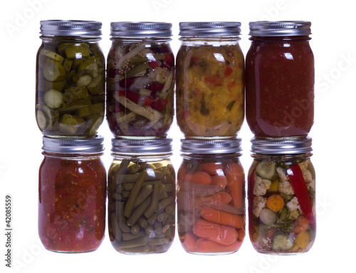 Photo: Group of fresh homemade preserved vegetables isolated on white Group of fresh homemade preserved vegetables isolated on white