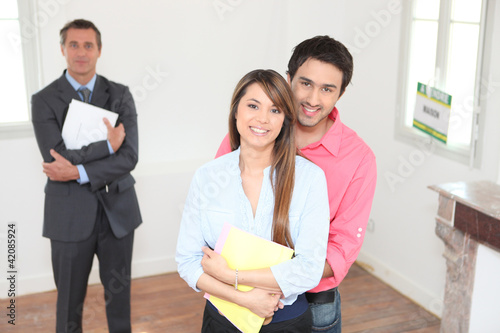 Photo: Happy young couple visiting house Happy young couple visiting house