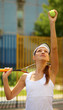 Young female tennis player getting ready to serve the ball