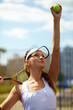 Young female tennis player getting ready to serve the ball