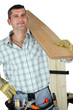 Handyman holding plank