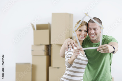 Photo: Young couple moving in new home Young couple moving in new home