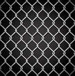 Metal fence on a dark background.