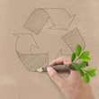 Male hand drawing recycle symbol on Brown Recycled Paper.