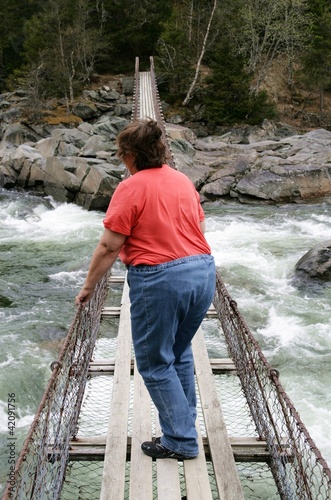 Photo: Obese woman on a suspension bridge Obese woman on a suspension bridge
