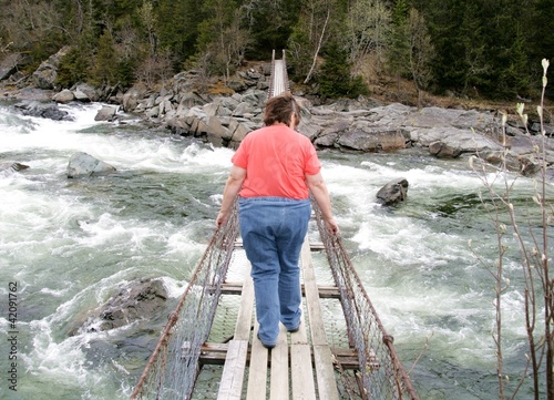 Photo: Obese woman on a suspension bridge Obese woman on a suspension bridge
