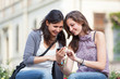 Two Beautiful Women Sending Messages with Mobile