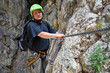 Foto: Young man climbing on via ferrata Young man climbing on via ferrata