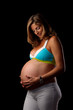 pregnant woman looking at her belly