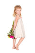 little girl holding flowers behind her back