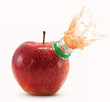 Foto: Red apple with bottle neck and juice splashes on white Red apple with bottle neck and juice splashes on white