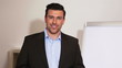 Business man in office holding a sales pitch with flipchart