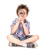 Photo: Attentive little boy with weird hair researching using magnifier Attentive little boy with weird hair researching using magnifier
