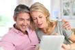 Couple at home using electronic tablet