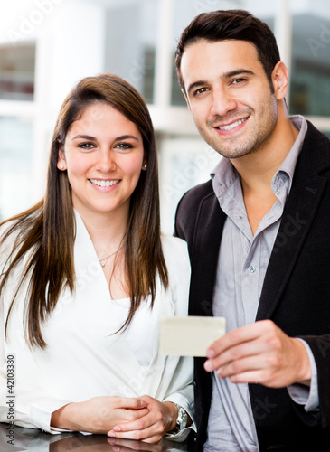Photo: Couple holding a credit card Couple holding a credit card