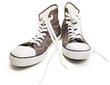 Photo: Two brown sneakers. Two brown sneakers.