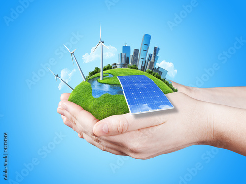 Photo: Hands holding clear green meadow with sun battery block Hands holding clear green meadow with sun battery block