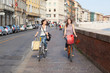 Two Beautiful Women Going by Bicycle