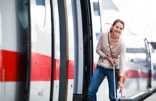 Photo: Pretty young woman boarding a train Pretty young woman boarding a train