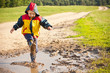 Photo: Boy splashing in puddle Boy splashing in puddle