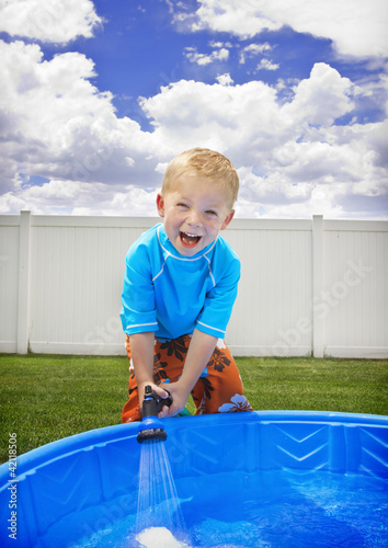 Photo: Little Boy playing outside in the Summer Little Boy playing outside in the Summer