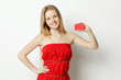 Young smiling woman holding blank credit card