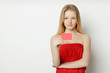Young woman holding blank credit card
