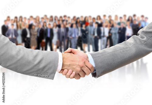 Photo: shaking hands and business team shaking hands and business team