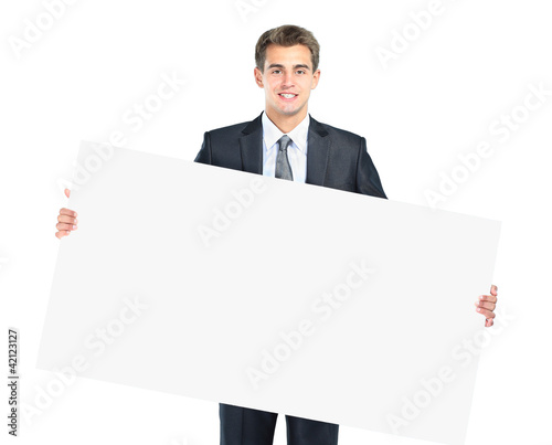 Photo: Happy smiling young business man showing blank Happy smiling young business man showing blank