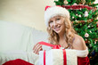 Beautiful young woman smiling with a gift in her hands