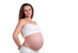 Photo: Portrait of a young pregnant woman over white Portrait of a young pregnant woman over white