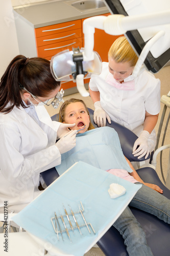 Photo: Dental assistant with dentist and little child Dental assistant with dentist and little child
