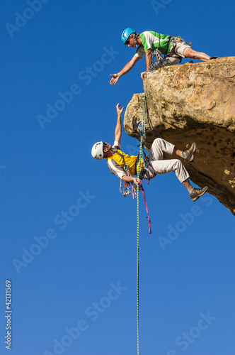 Photo: Climbing team struggles to the summit. Climbing team struggles to the summit.