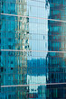Reflections in modern glass-walled building facade