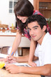 Couple writing on the kitchen table