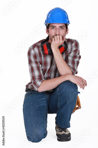 Photo: helmeted craftsman with earmuffs isolated on white helmeted craftsman with earmuffs isolated on white