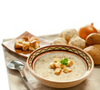 Soup and ingredients on the tablecloth, isolated on white